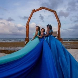 Friends celebrating with a Flying Dress group photoshoot in Cancun